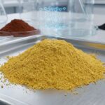 A vibrant mound of high-purity yellow iron oxide powder in a lab setting, illustrating that yellow iron oxide is safe for industrial use.