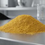 A vibrant mound of yellow iron oxide powder pigment (PY 42) in a clean industrial lab, highlighting its fine texture for use in coatings and concrete.